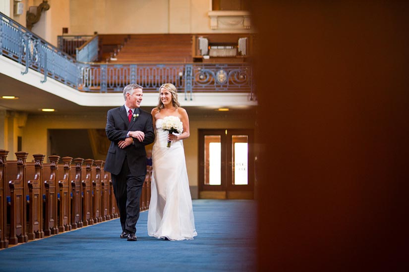 bride comes down the aisle at us naval academy chapel