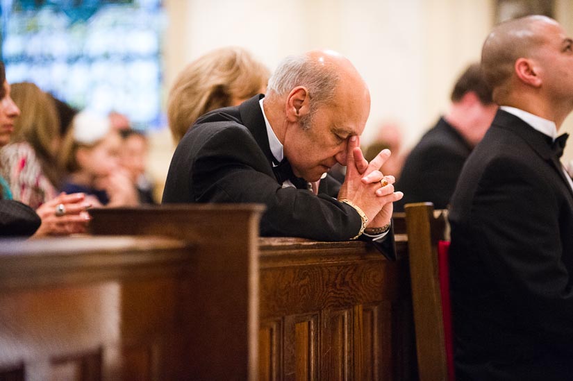 father of the groom praying at holy rosary church
