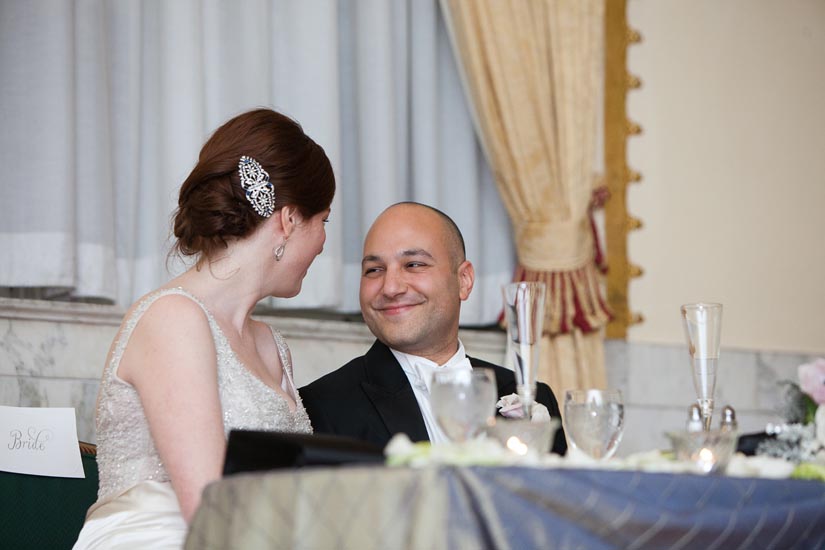 bride and groom listening to speeches