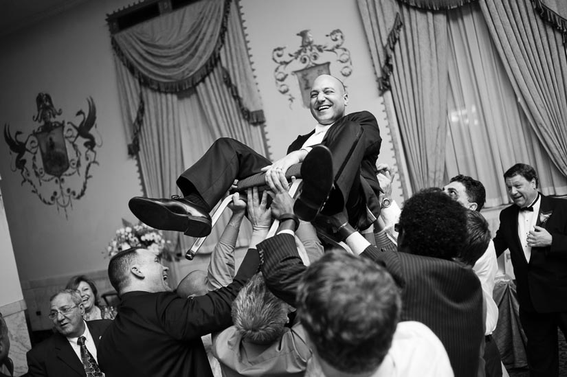 groom being hoisted in a chair