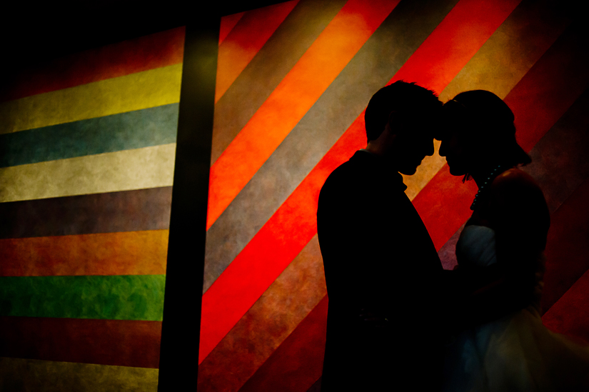 emilie-zack-wedding_097 silhouette with modern art and bride and groom