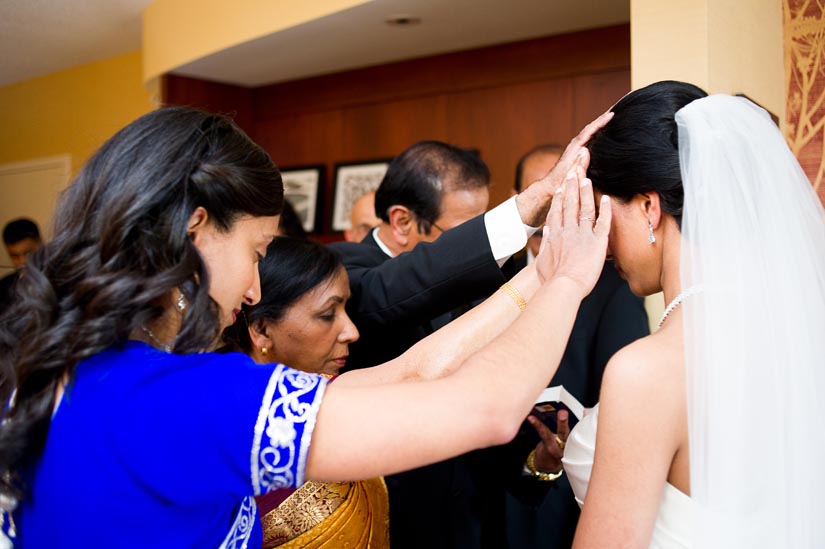 family prays before wedding