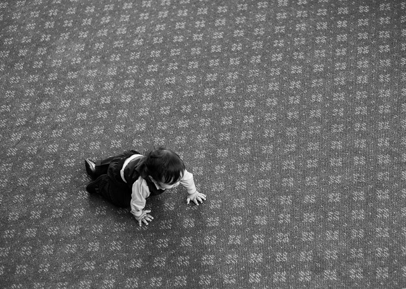 little baby on a patterned carpet during wedding