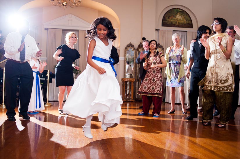 flower girl jumping at wedding reception