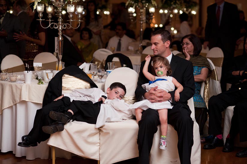 little boys tuckered out at the wedding reception