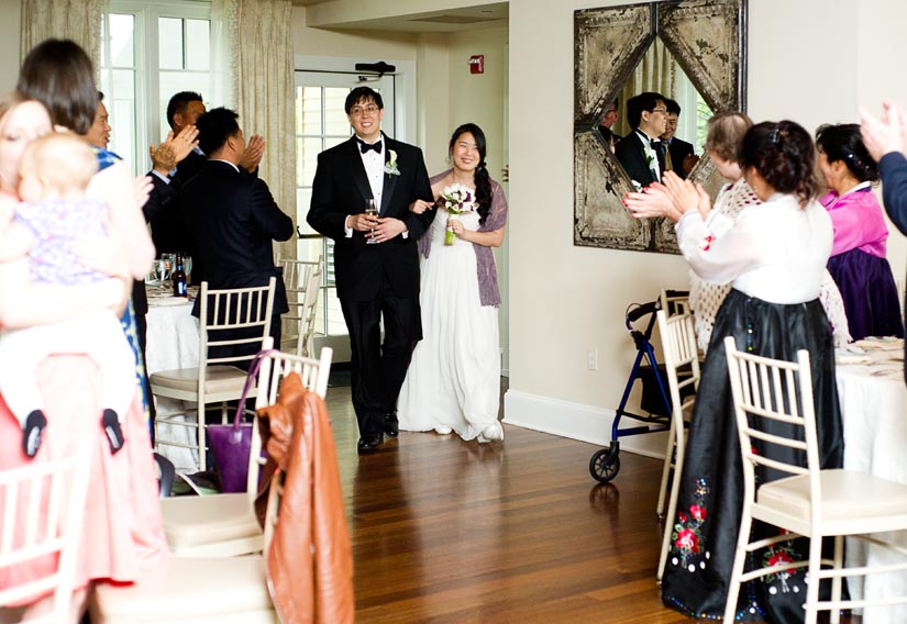 bride and groom enter the oaks wedding reception