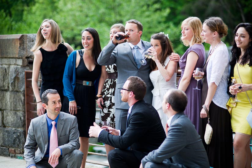 bride and groom drinking during portraits