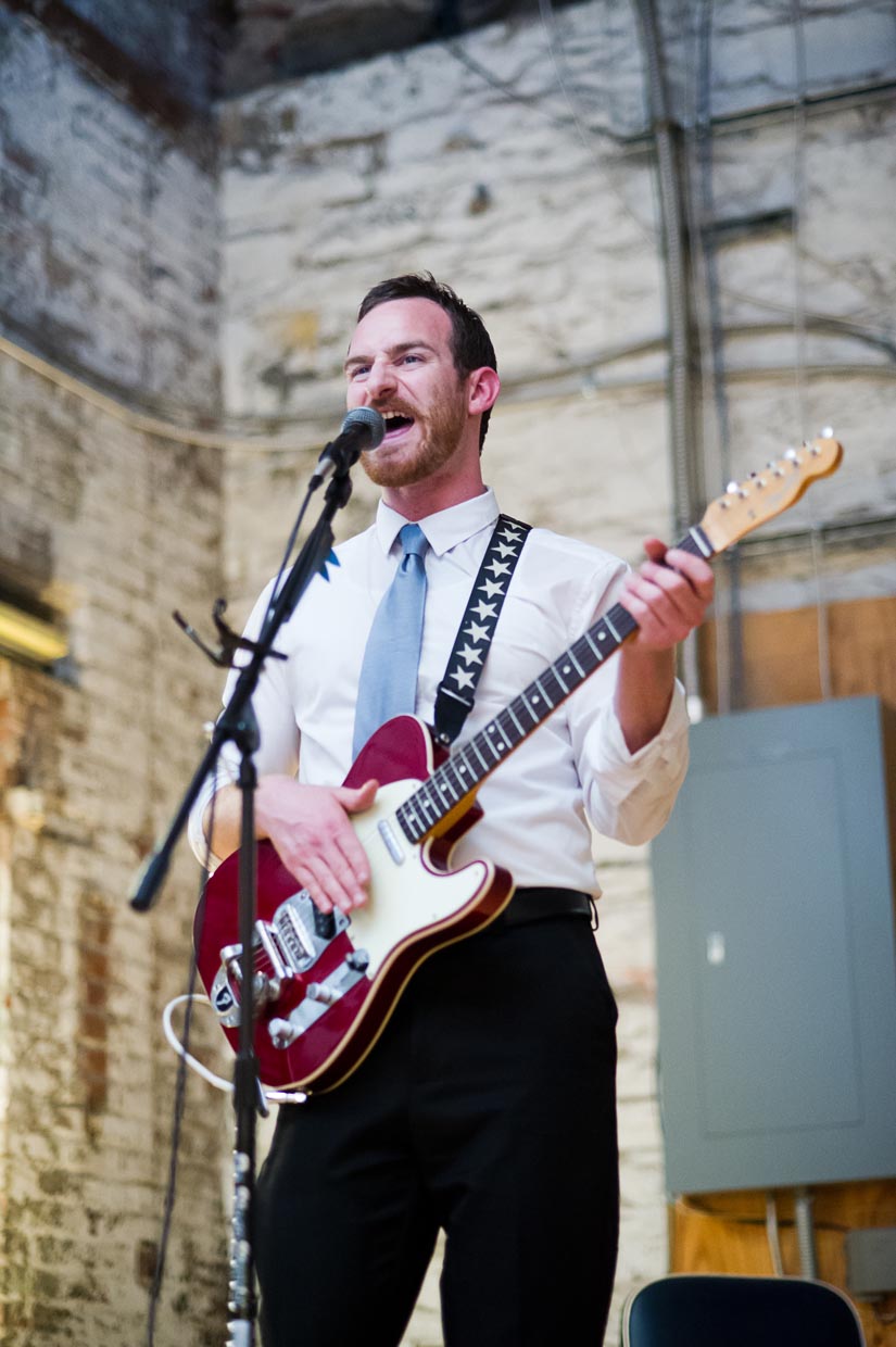 friend playing guitar at a wedding