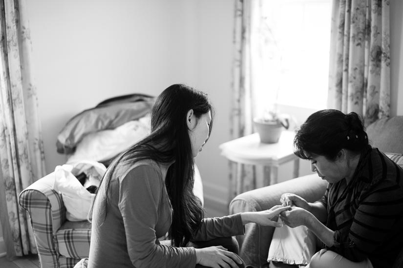 bride and her mom getting ready before the wedding ceremony