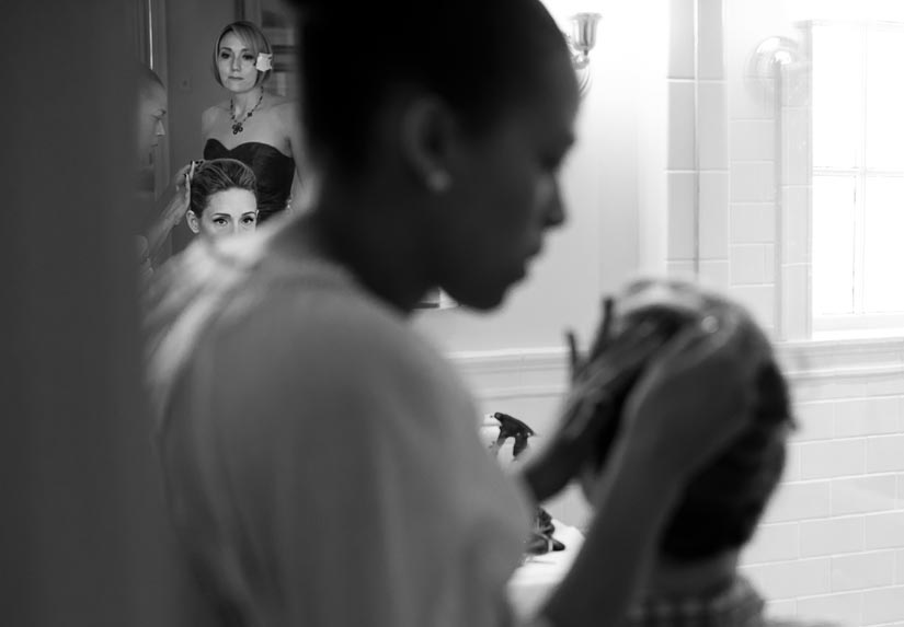 bride gets her hair done before the wedding