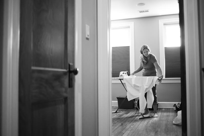 mom irons her son's shirt for the wedding