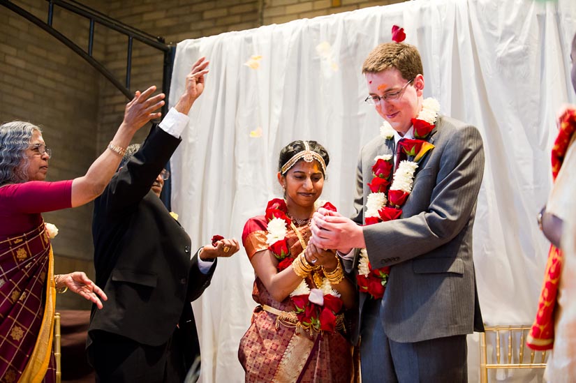 throwing flowers during indian wedding ceremony