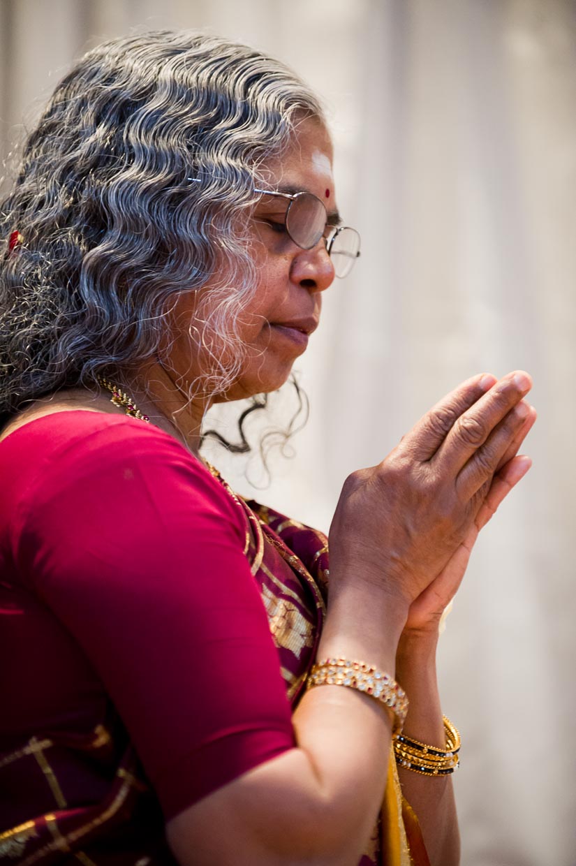 mother of the bride praying during wedding ceremony