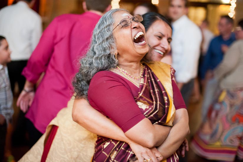 mom and friend laughing at st. francis hall indian wedding