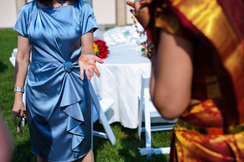 mother of the groom shows her henna