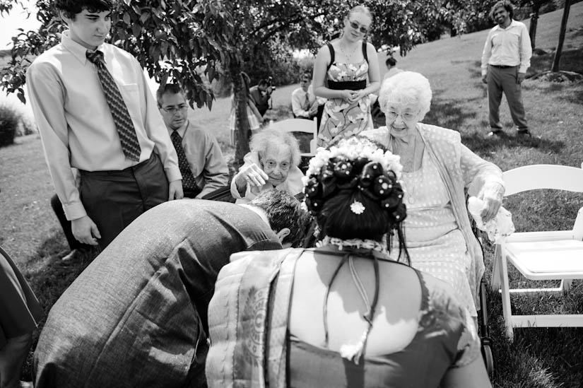 grandmother throws rice during indian wedding ceremony