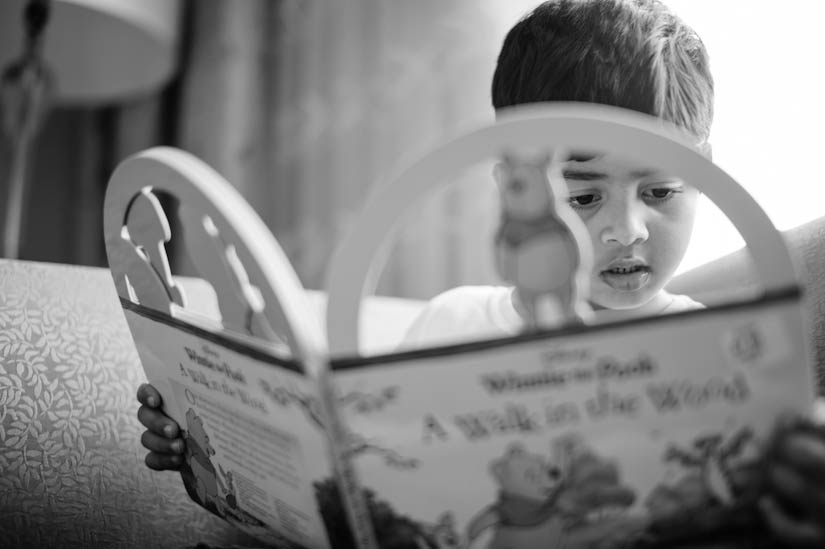 little boy reads Pooh book during wedding