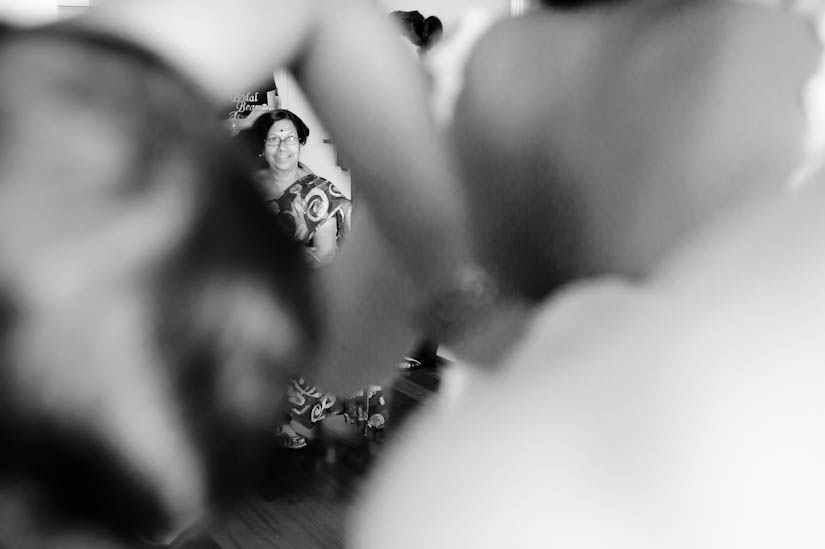 mother of the bride watches her get dressed