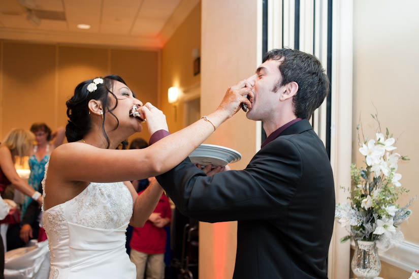 feeding each other cake at the wedding reception