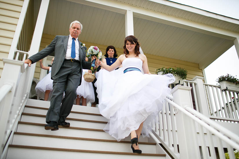 bride walks out of front door for wedding
