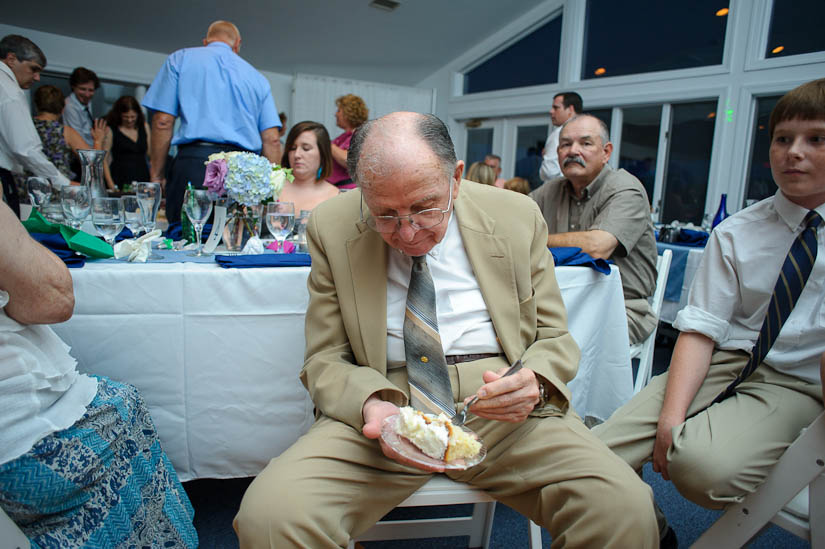 grandfather eating cake at wedding reception