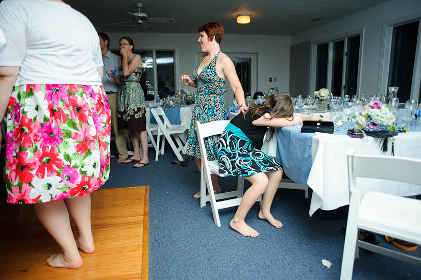 little girl sleeping at a wedding reception