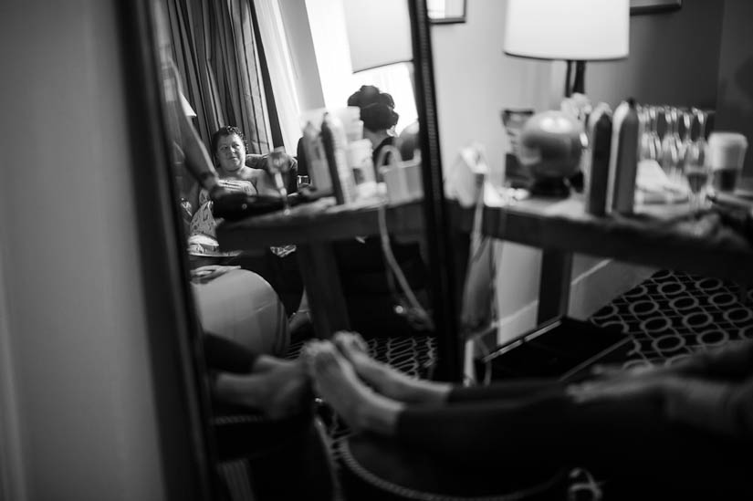 mother of the bride looks on as daughter gets her hair done