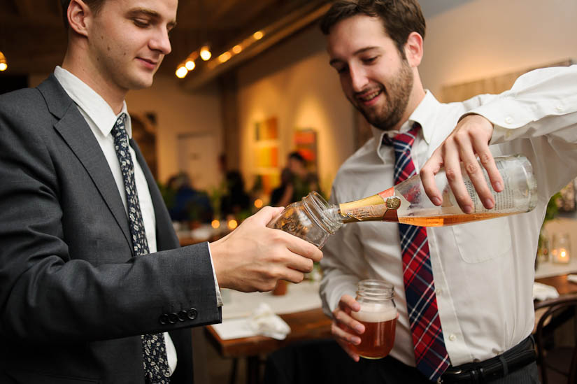 pouring campagne into mason jars at the longview gallery wedding