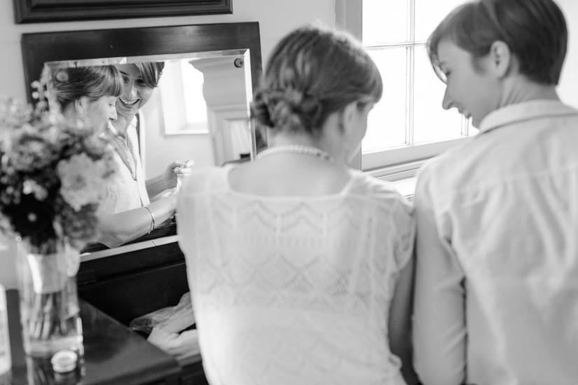 bride and bridesmaid laughing at woodlawn manor wedding