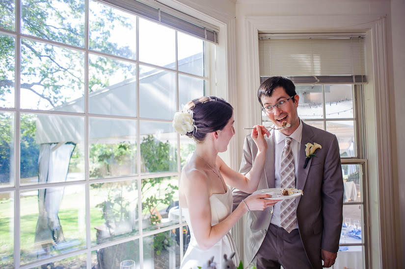 eating the cake at mountain lakes house wedding reception