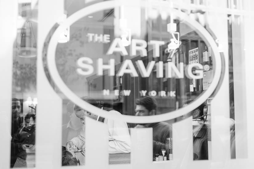groom getting a shave at the art of shaving
