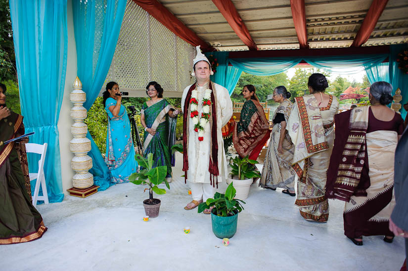 receiving groom at garden falls indian wedding