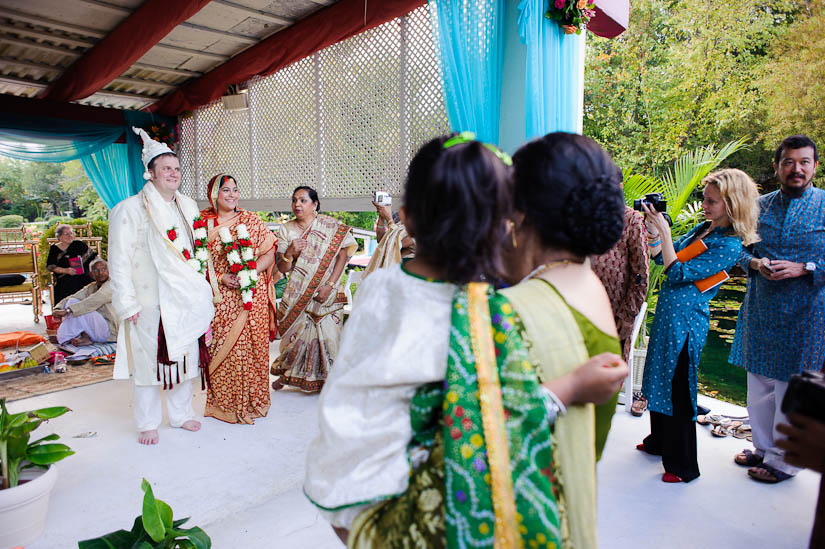 bride and groom greeted by friends and family