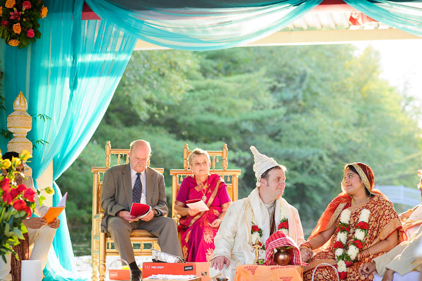 bride and groom exchange a glance during garden falls indian wedding