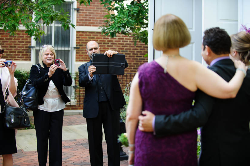 priest taking photos with an ipad