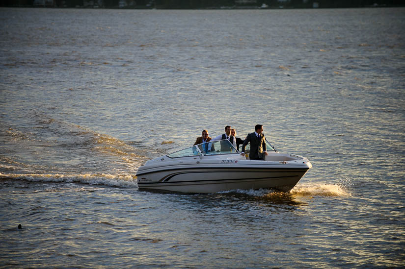 groom arriving for the wedding by boat