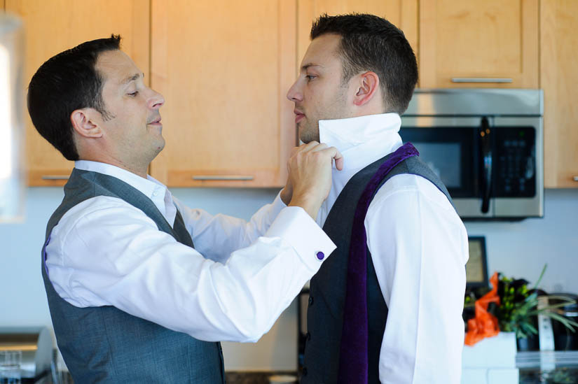 grooms putting on each others' ties