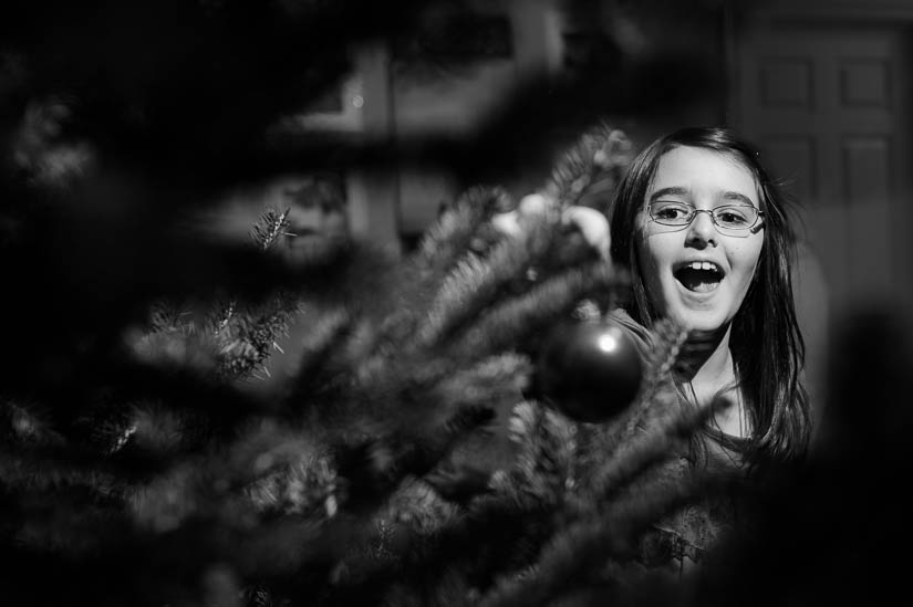 putting ornaments on the tree during documentary family session