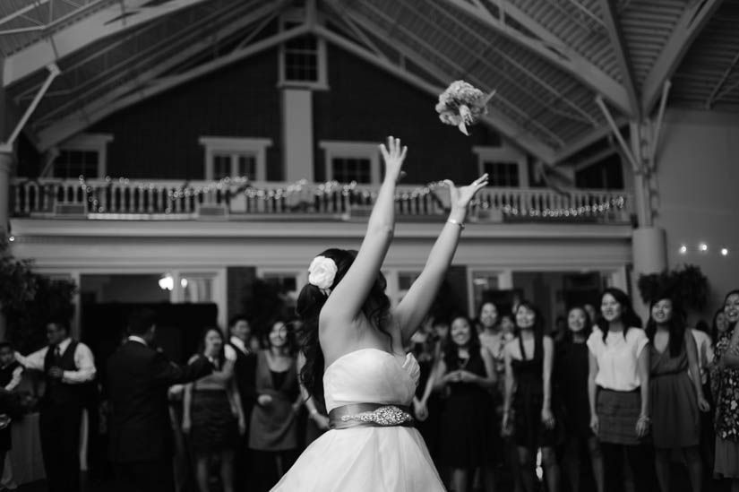 bride throwing the bouquet at raspberry plain wedding