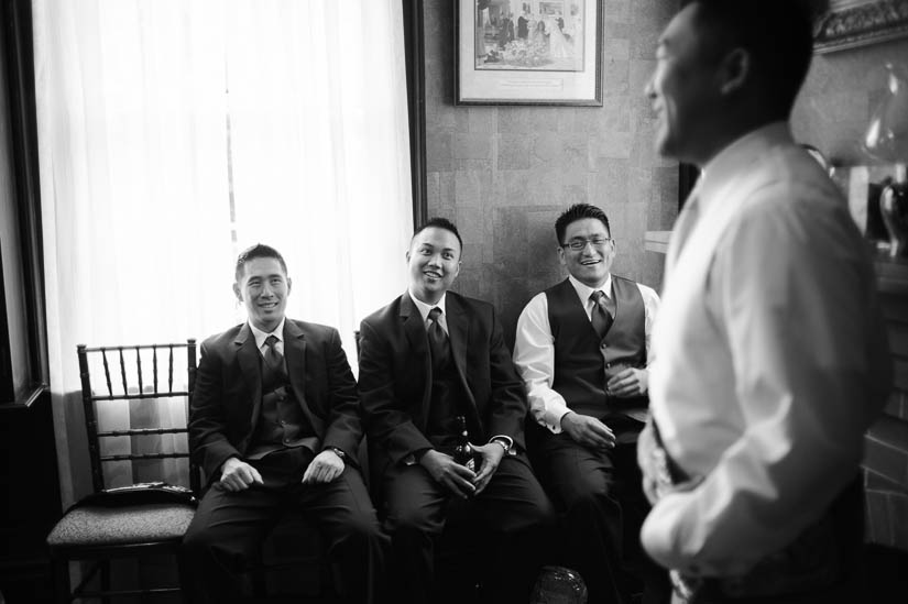 groomsmen laughing with the groom