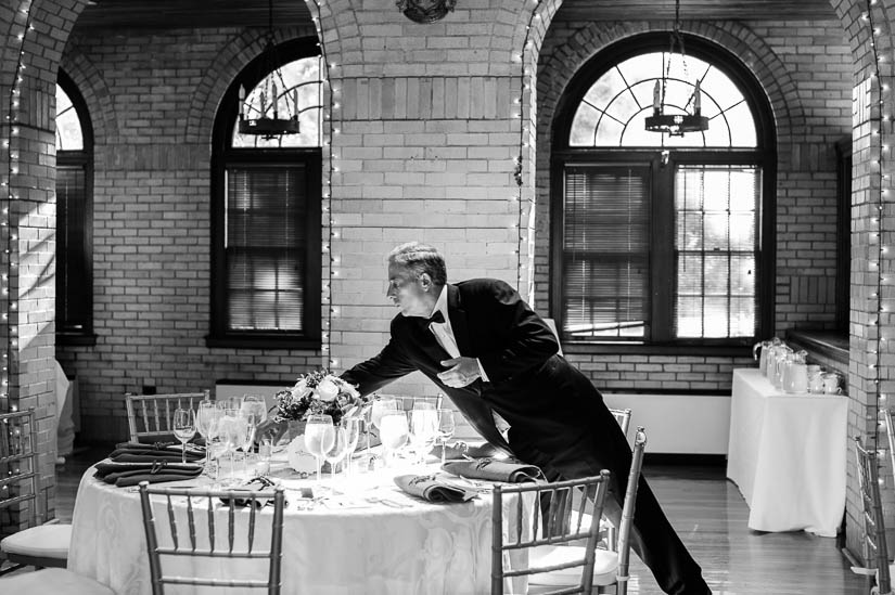 waiter arranging table at st. francis hall wedding