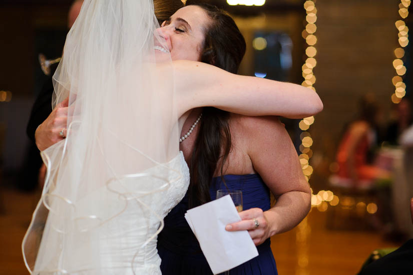 hugging the bride on her wedding day