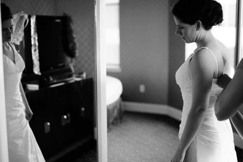 bride puts on her dress at the baltimore hotel monaco