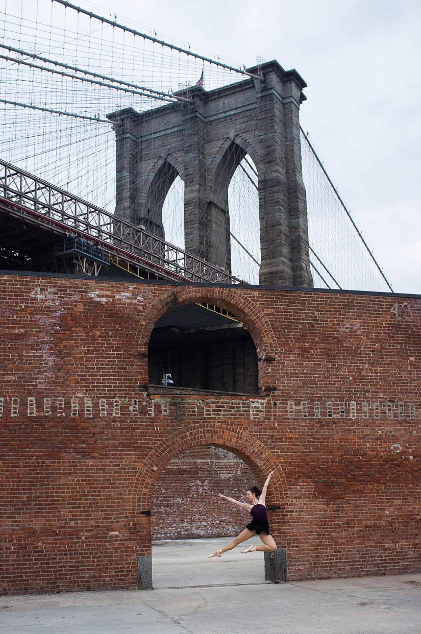 ballerina dancing below the brooklyn bridge