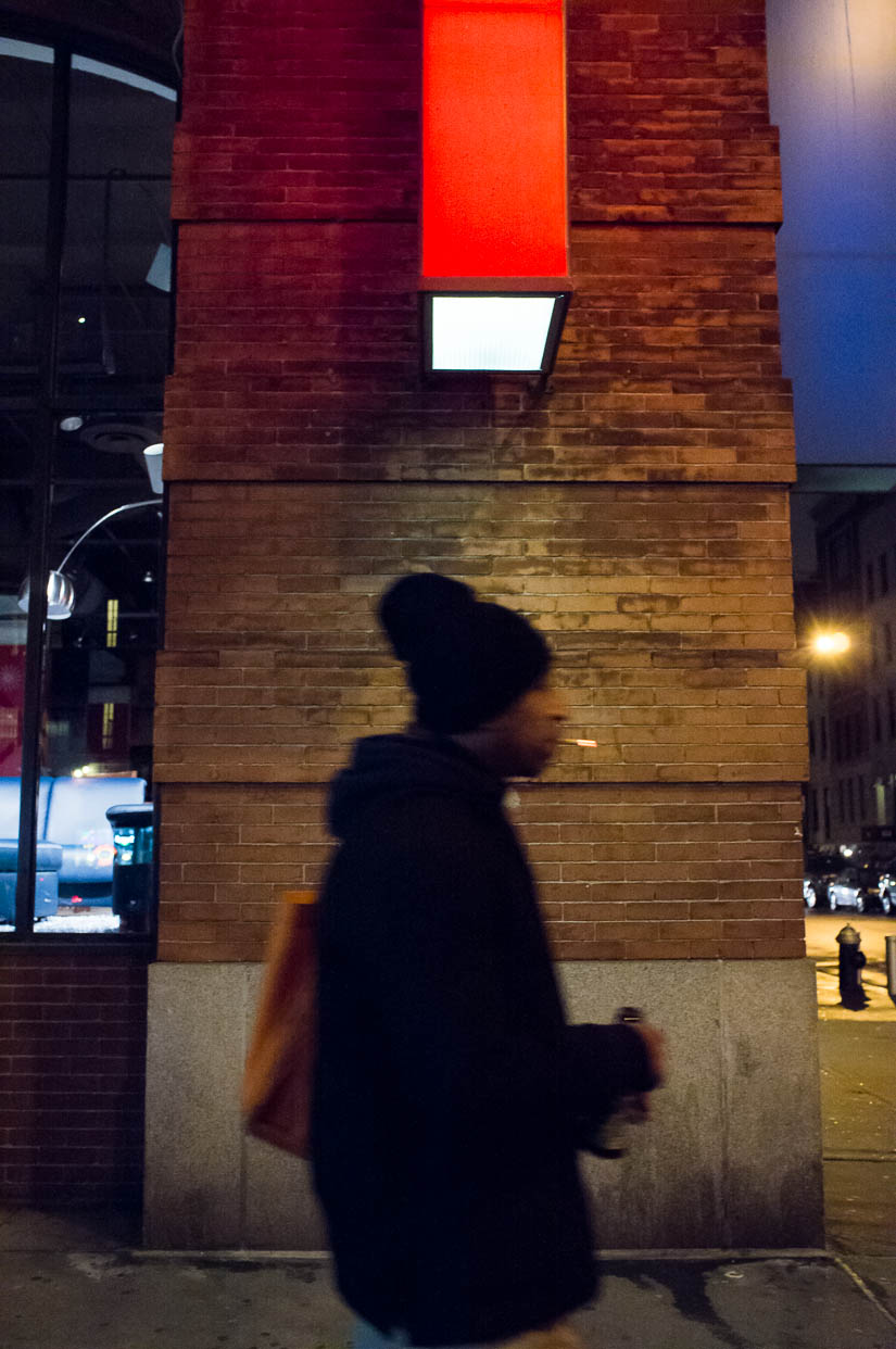 guy walking on the street with cigarette and red