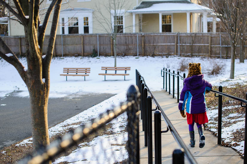 little girl walking to the playground in a cheetah hat