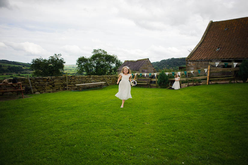 little girl running into the camera at danby castle wedding