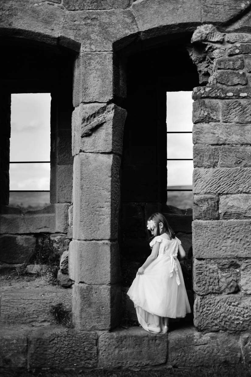 little girl in castle ruins in north yorkshire, england