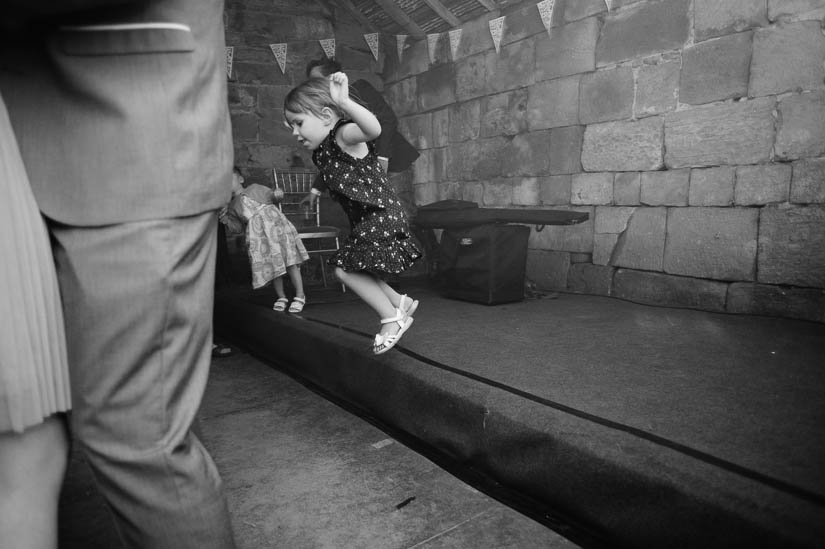 little girl jumping off the stage at danby castle wedding