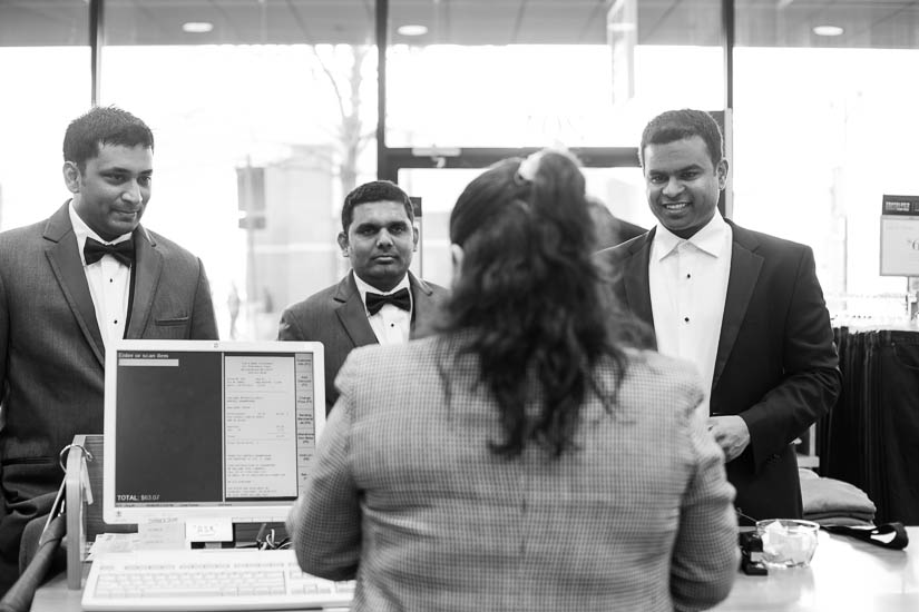 groom buying a bow tie at the menswear store